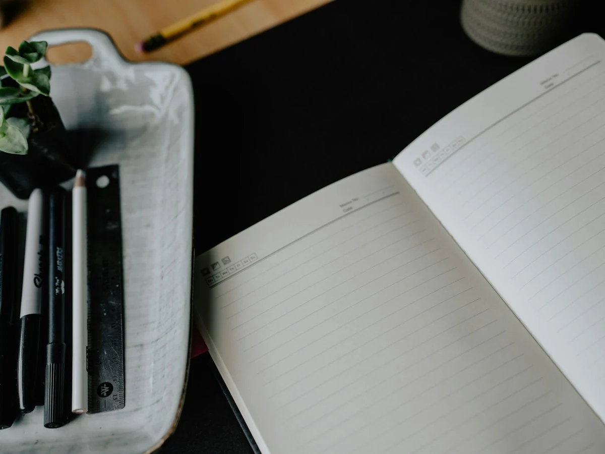 Open notebook and pens ready for a responsibility brief