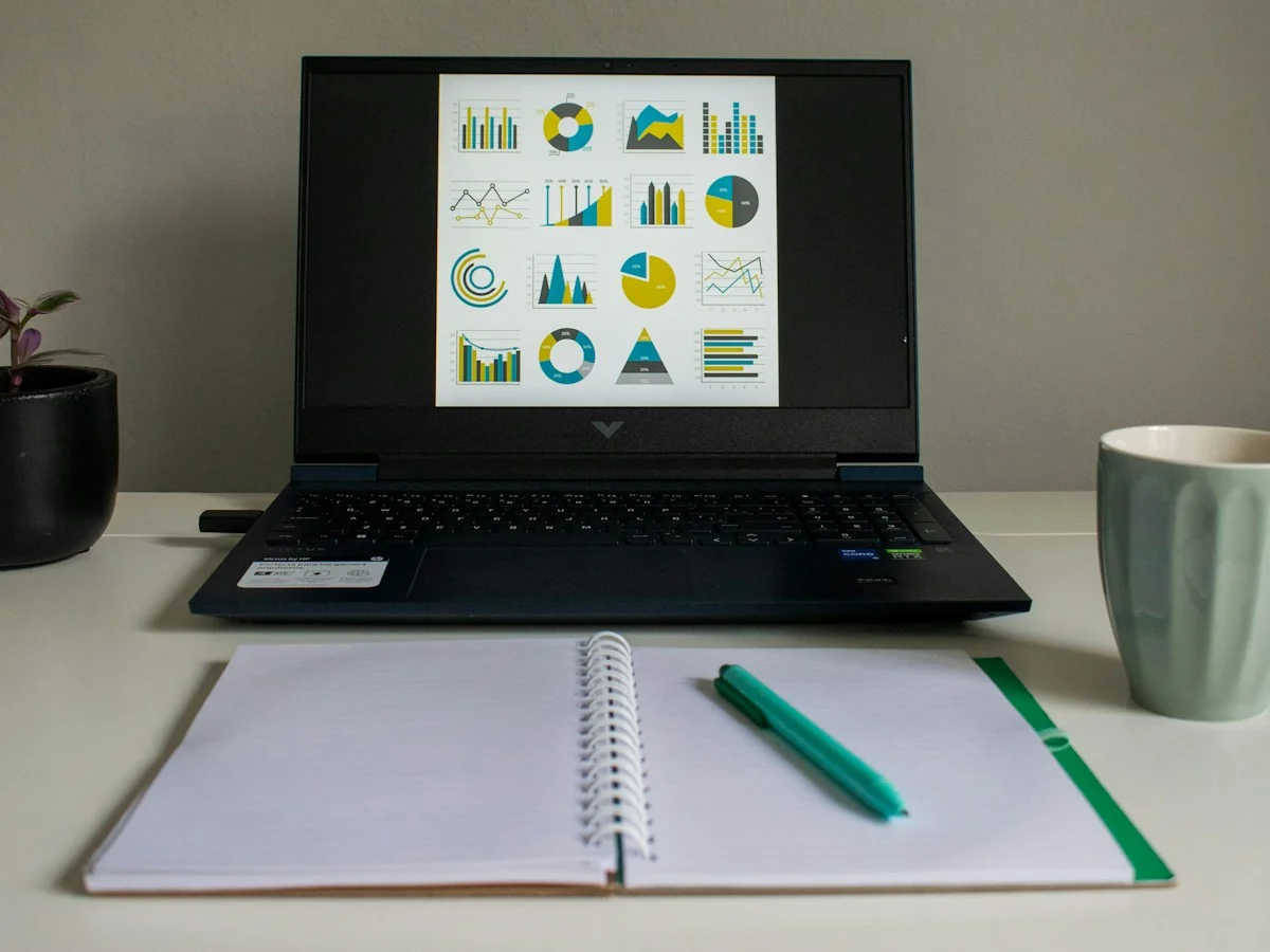 Charts displayed beside a notebook and mug