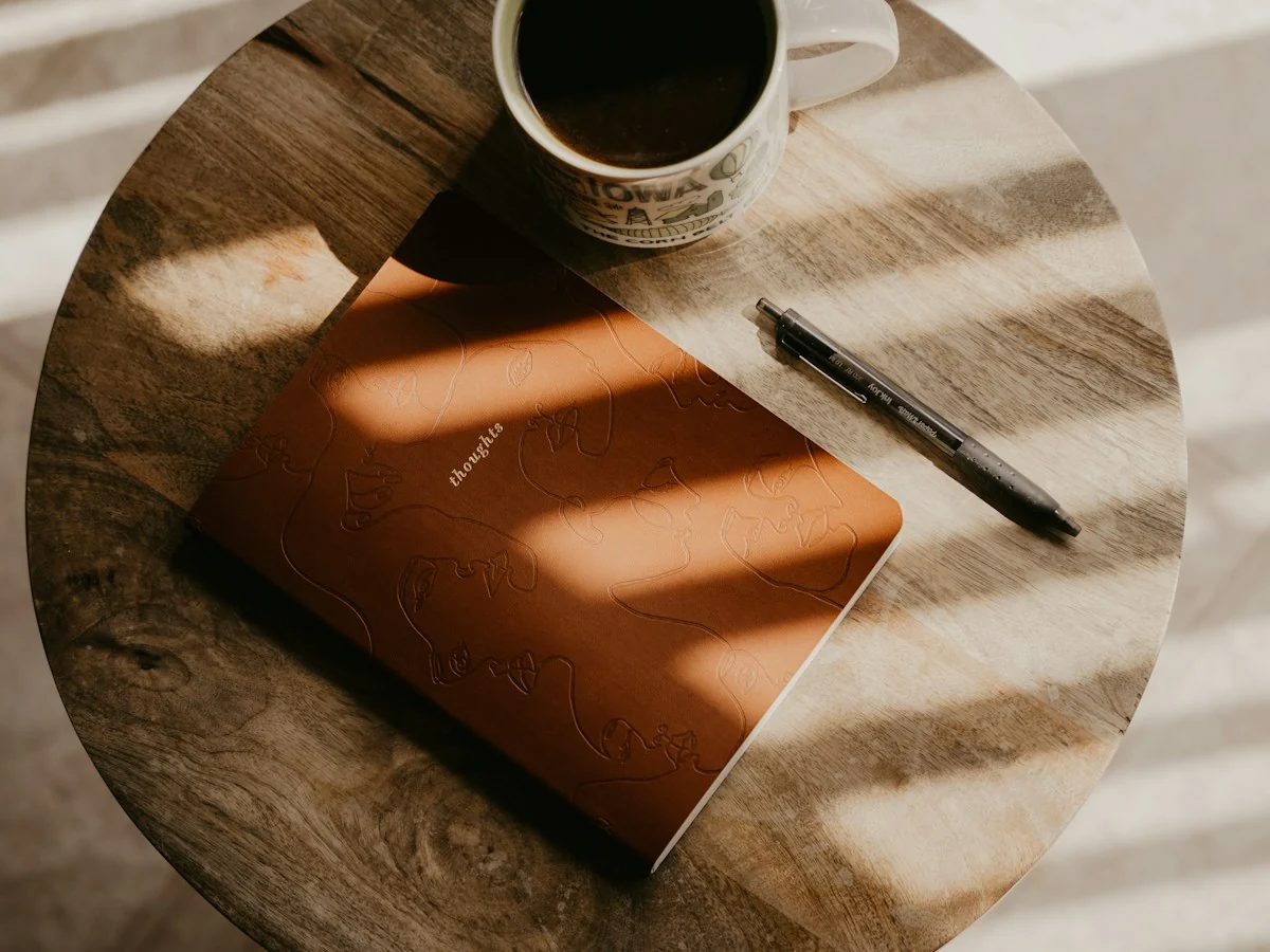 Notebook and coffee in warm daylight